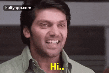 a man is smiling and says hi .