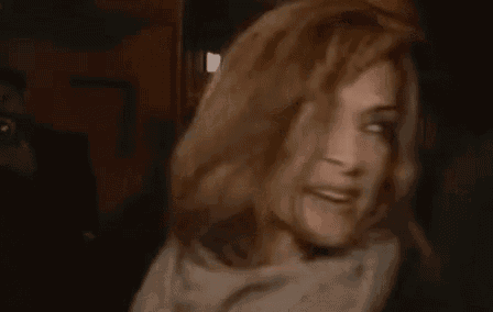a blurry picture of a woman wearing a scarf and a scarf with a foreign language written on it .