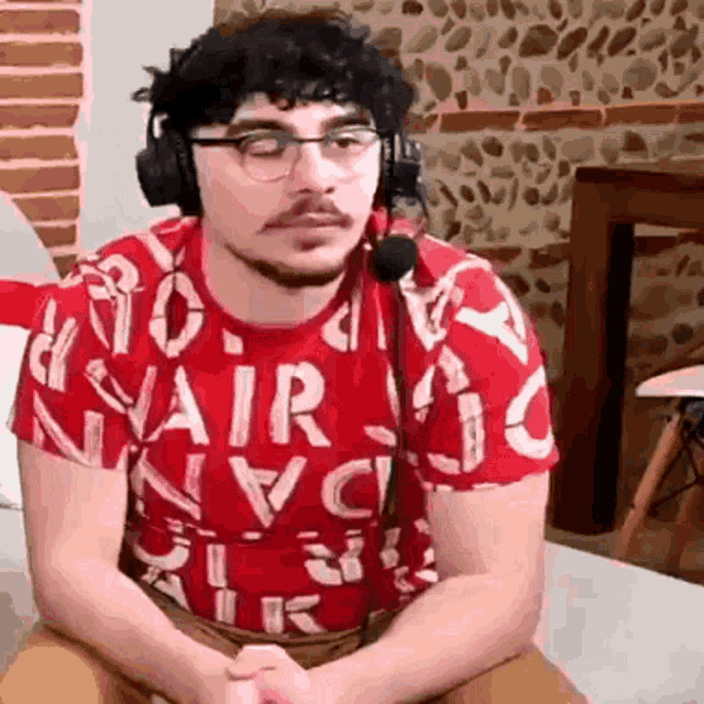 a man wearing headphones and a red shirt with the word air on it