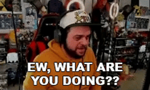 a man wearing a hat and headphones says ew what are you doing ?