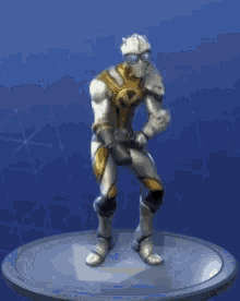 a statue of a knight in armor is dancing on a blue surface .