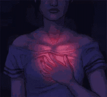 a woman is holding her chest with her hands and there is a light coming out of it .