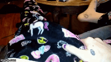 a person wearing a pair of pajamas with a unicorn on them