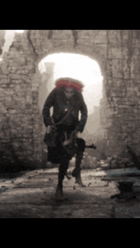 a man in a mask is holding a gun in front of a brick wall