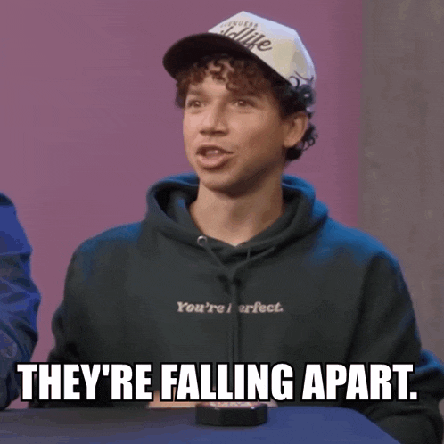 a young man wearing a hat and a hoodie says they 're falling apart