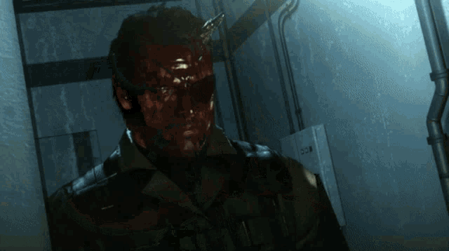 a man with blood on his face is standing in a dark hallway