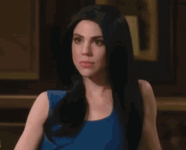 a woman in a blue top with surprise bitch written below her