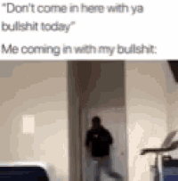 a man is standing in a doorway in a room with a reflection of him in the doorway .
