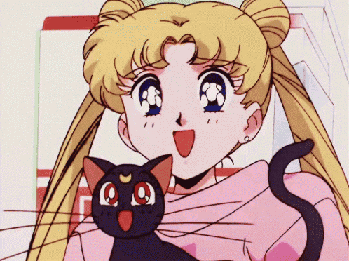 a girl in a pink sweater is holding a black cat with a red nose