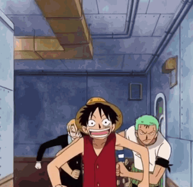 luffy from one piece is standing in a hallway with two other people .
