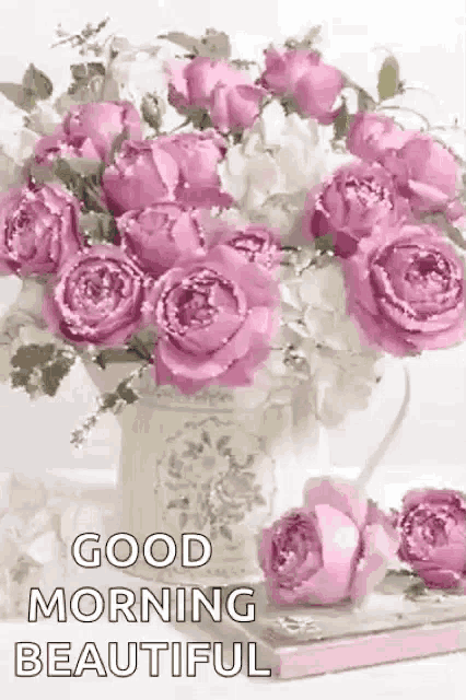 a vase filled with pink and white roses with the words `` good morning beautiful '' written on it .