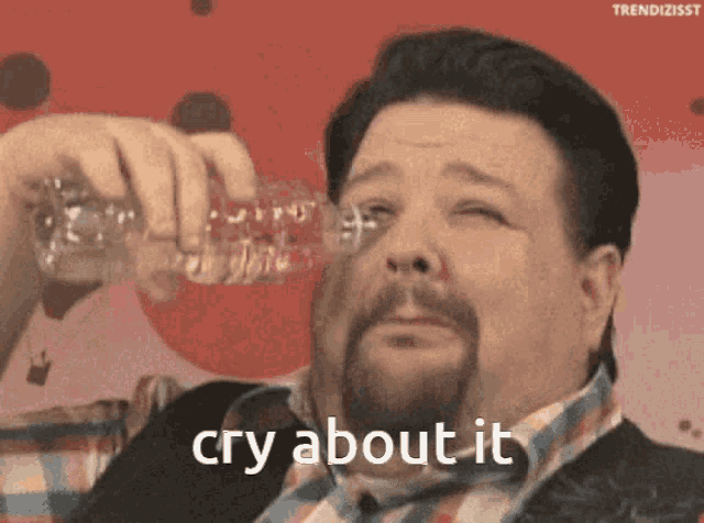 a man with a beard is holding a bottle of water in his hand and says cry about it