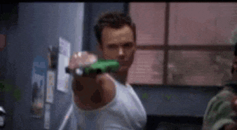 a man is holding a green object in his hand .