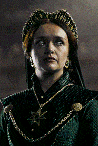 a woman in a green dress has a star necklace