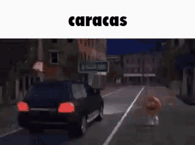 a car is driving down a street with a sign that says caracas .