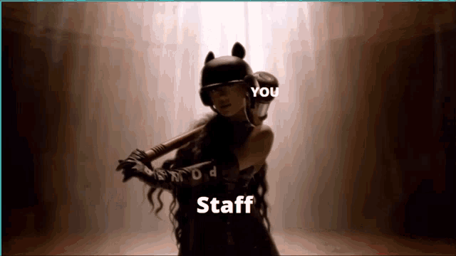 a woman in a cat costume is holding a bat and the words staff are on the bottom