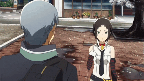 a man and a girl are standing on a brick sidewalk and the girl is wearing a tie
