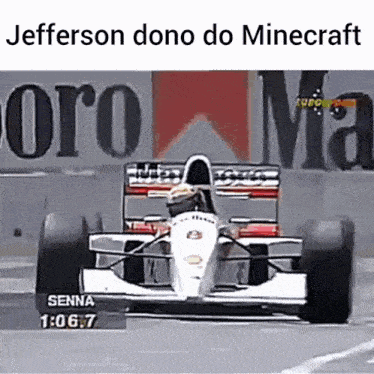 a race car is driving down a track in front of a sign that says jefferson dono do minecraft .