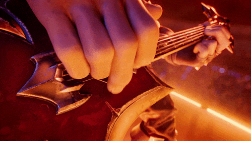 a close up of a person playing a guitar with a sword shaped headstock