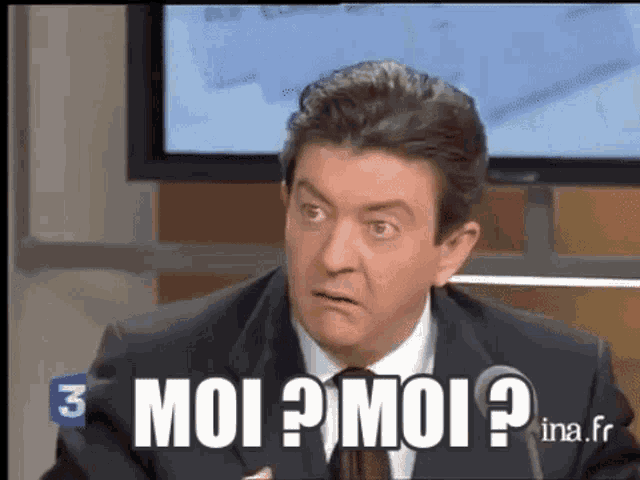 a man in a suit and tie says " moi "
