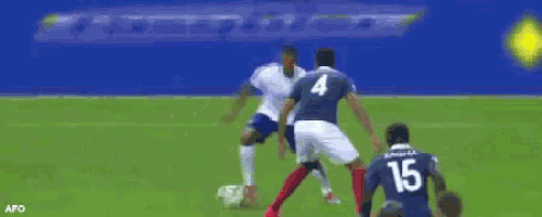 a group of soccer players are playing on a field with a pasquier ad in the background