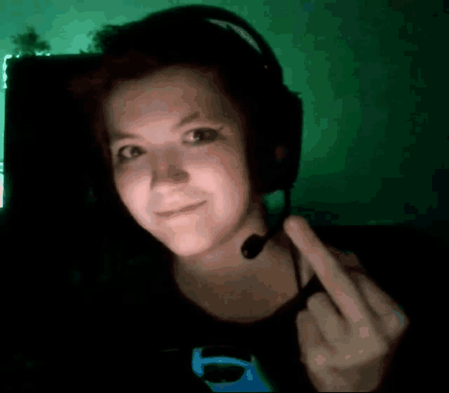 a girl wearing headphones and a microphone giving the middle finger