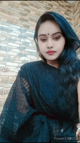 a woman with blue hair is wearing a black dress