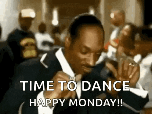 snoop dogg is wearing a suit and tie and is dancing in a crowd .