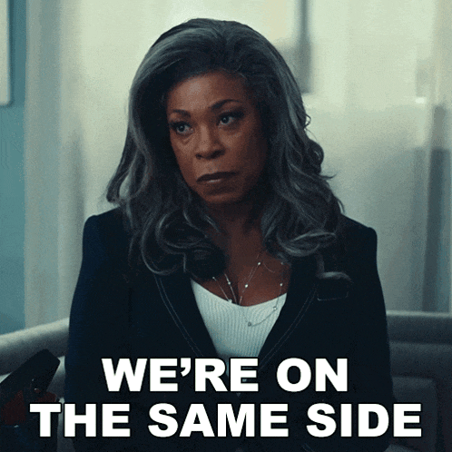 a woman sitting in a chair with the words we 're on the same side behind her