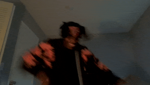 a blurry picture of a person in a black and red shirt