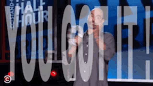 a man is standing in front of a sign that says " you got it "