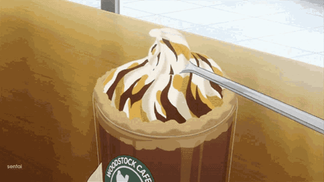 a cup of woodstock cafe with whipped cream on top