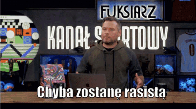 a man in front of a sign that says fukstarz