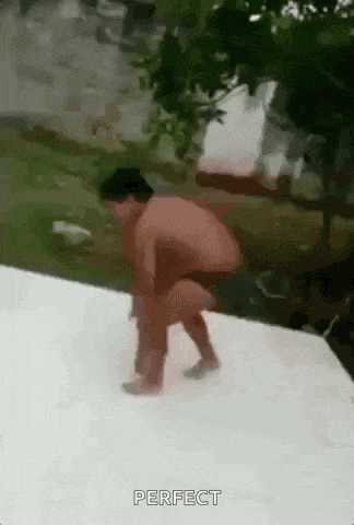 a naked man is standing on a white surface .