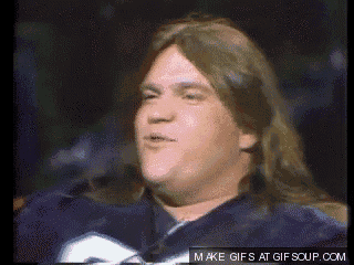 a man with long hair is wearing a blue jersey with the letter g on it