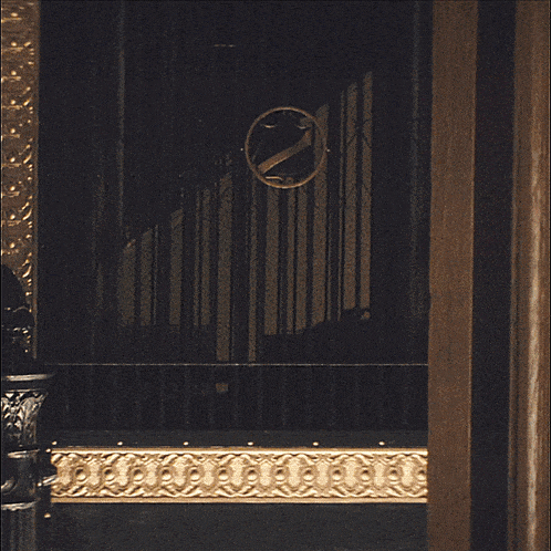 a dark room with a clock on the wall with the letter z on it