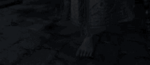 a woman 's feet are visible in the dark