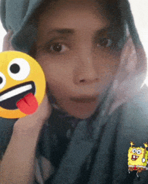 a woman wearing a blue scarf has a spongebob sticker on her face