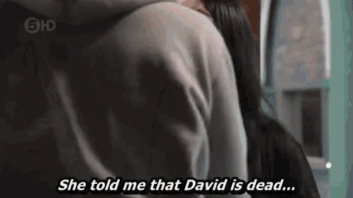 a man and a woman are standing next to each other and the woman says `` she told me that david is dead . ''