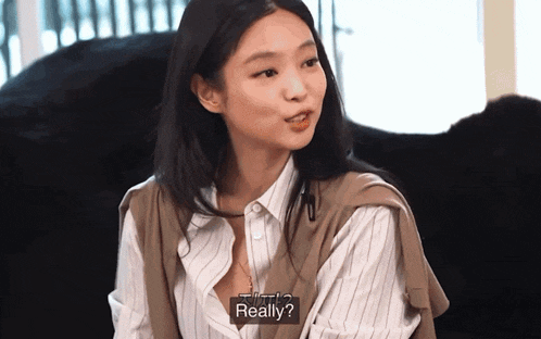 a woman in a striped shirt says really in a video