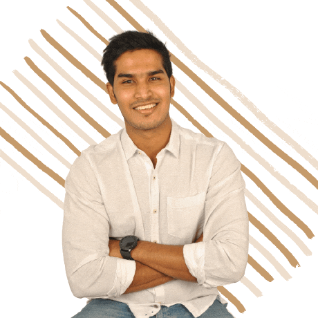 a man in a white shirt with his arms crossed smiles
