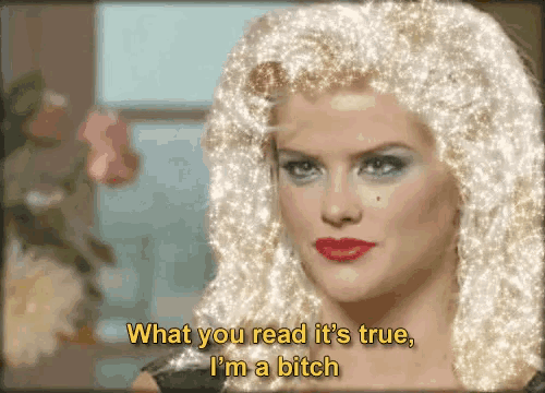 a woman in a wig says what you read it 's true i 'm a bitch