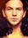 a close up of a man 's face with his eyes closed and a blurred background .