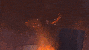 a light bulb is on fire in a dark room with a blurred background