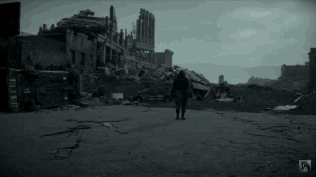 a person walking through a destroyed city with a skull logo on the bottom right corner