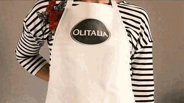 a woman wearing a white apron that says olitalia