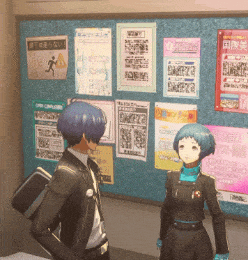 a man and a woman are standing in front of a bulletin board with posters on it