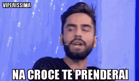 a man with a beard is making a funny face with the words na croce te prenderai above him