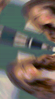 a blurry picture of a person 's face with a blue background .