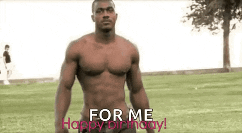 a shirtless man is standing in a field with the words `` for me happy birthday '' written on it .